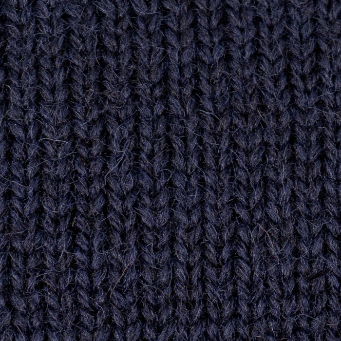 Detailed macro texture shot of 100% British wool navy blue knit yarn
