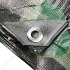 Close-up of metal eyelet grommet and reinforced corner patch on woodland camo tarp