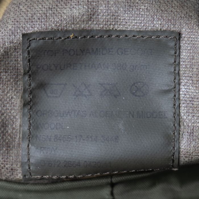 Close-up of the internal label on a Dutch Army pouch showing the NATO Stock Number NSN 8465-17-114-3448 and fabric details.