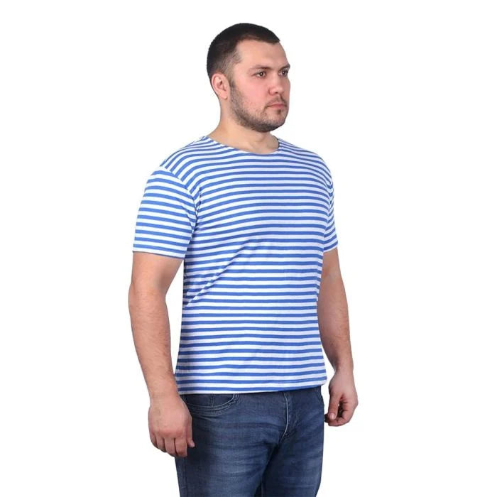 Male model wearing Russian Telnyashka short sleeve striped t-shirt with blue denim jeans