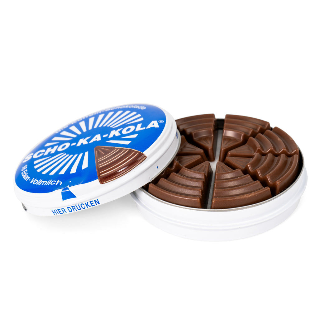 Open metal tin of Scho-Ka-Kola milk chocolate showing 16 wedge-shaped caffeinated chocolate pieces inside.