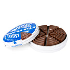 Open metal tin of Scho-Ka-Kola milk chocolate showing 16 wedge-shaped caffeinated chocolate pieces inside.