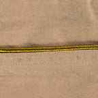 Close-up of green and yellow braided piping detail on an original WW2 US Army Garrison Cap.