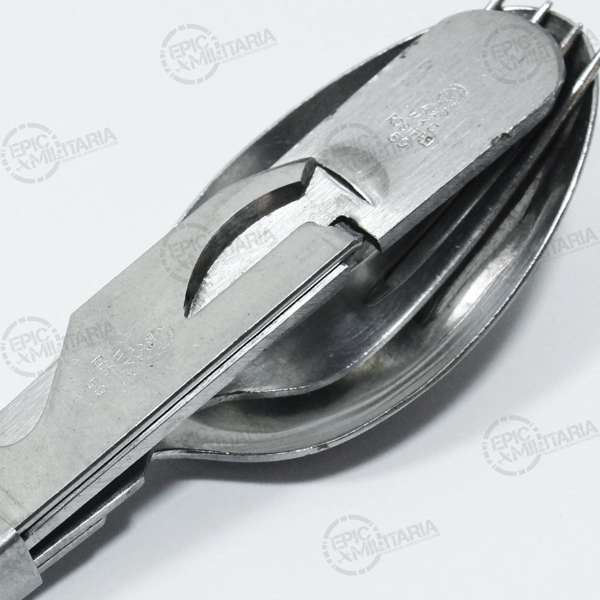 Close-up detail of German Army stainless steel utensil set showing stamped markings on the handle and interlocking design.