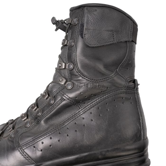 Side profile of the black leather Meindl Fliegerstiefel showing ankle ventilation perforations and reinforced heel stitching