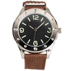 Front view of Eaglemoss Egyptian Naval Commando watch with black dial, pale green indices, and riveted bezel on a brown canvas strap.