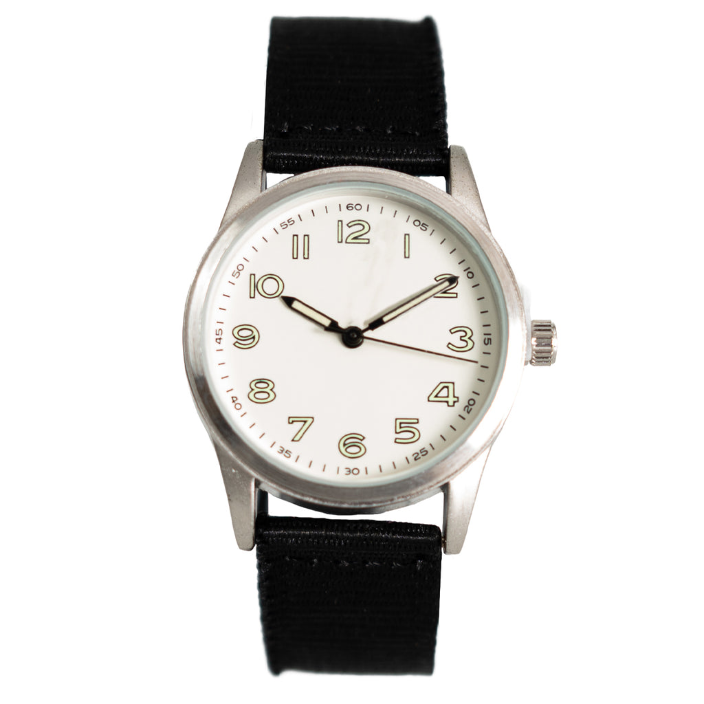 1940s French seaman style quartz watch with a white dial, bold Arabic numerals, and a black canvas strap.