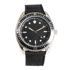 1960s German Naval Commando style watch with a black dial, luminous markers, fluted bezel, and black woven nylon strap.
