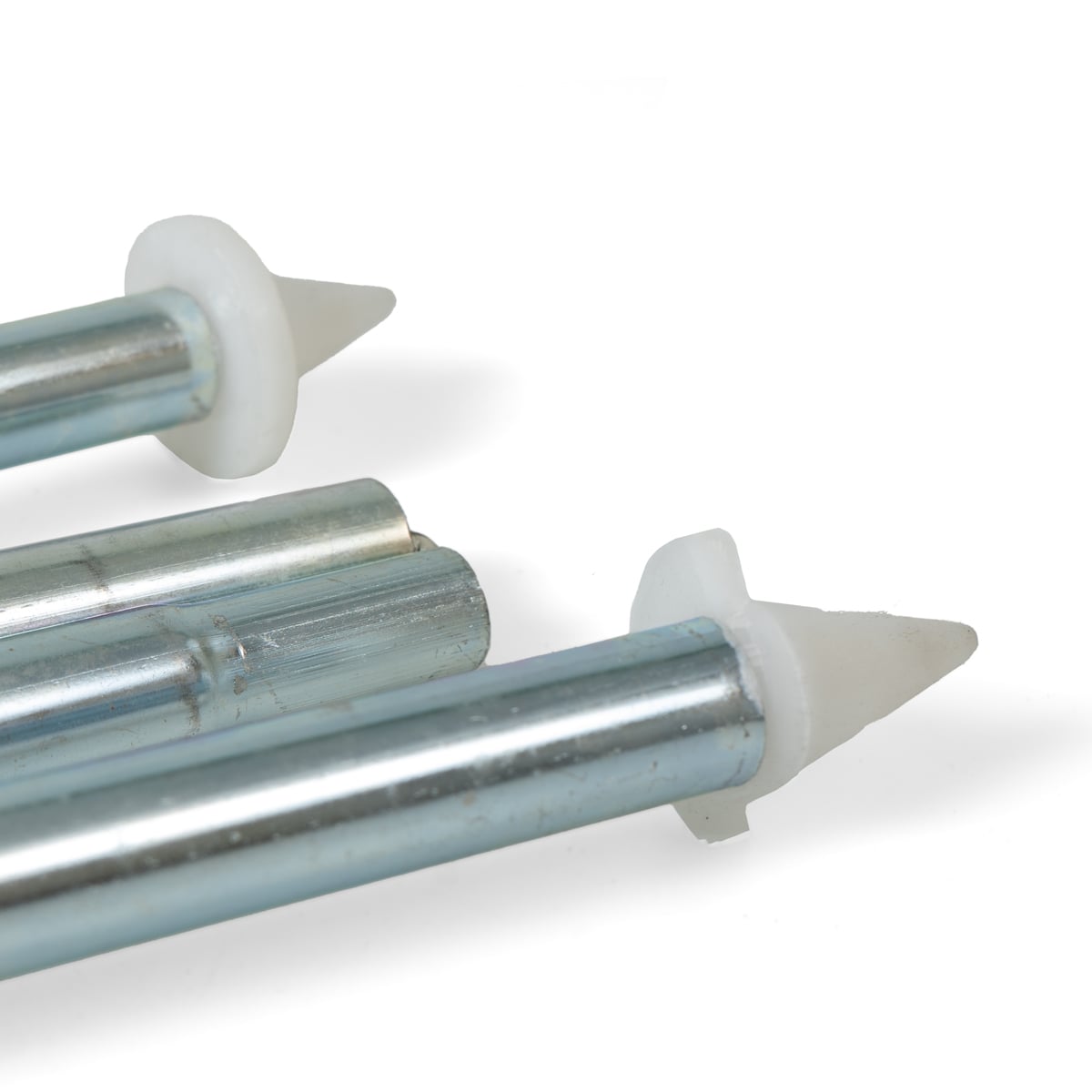 Close-up of modular galvanised steel tent pole ends featuring protective white plastic conical tips for tent fabric safety.