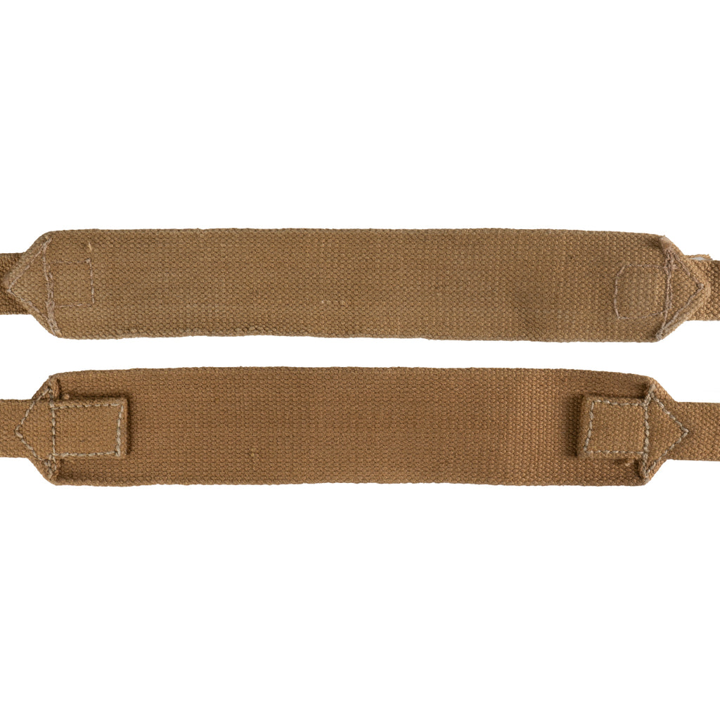 Pair of original British Army 37 pattern webbing straps made from durable tan cotton canvas, isolated on white.