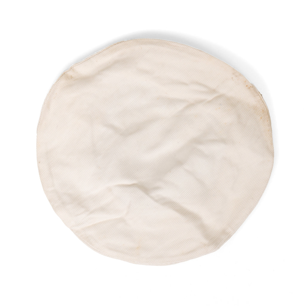 Top-down view of a circular, white cotton British Royal Navy cap topper showing its textured fabric and post-WW2 vintage condition.