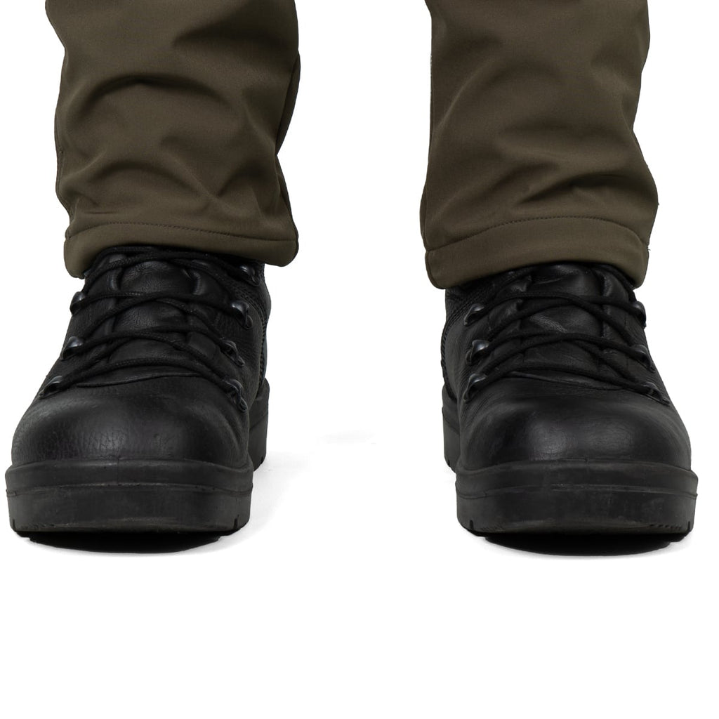 Front view of black tactical boots worn with olive trousers, showing the rounded toe and robust ankle support.