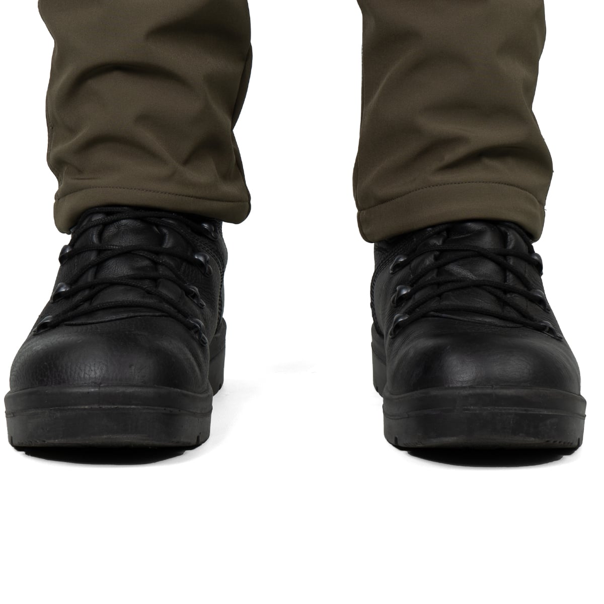 Front view of black tactical boots worn with olive trousers, showing the rounded toe and robust ankle support.