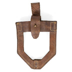 Front detail of a brown leather JNA shovel cover displaying authentic military surplus wear, brass hardware, and reinforced leather edge stitching.