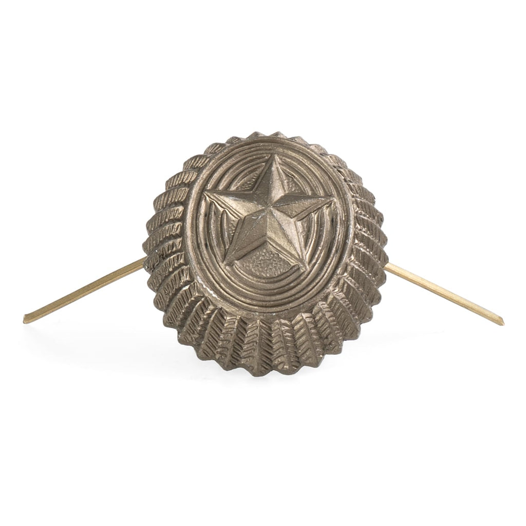 Metallic star-shaped object with ribbed texture on a white background