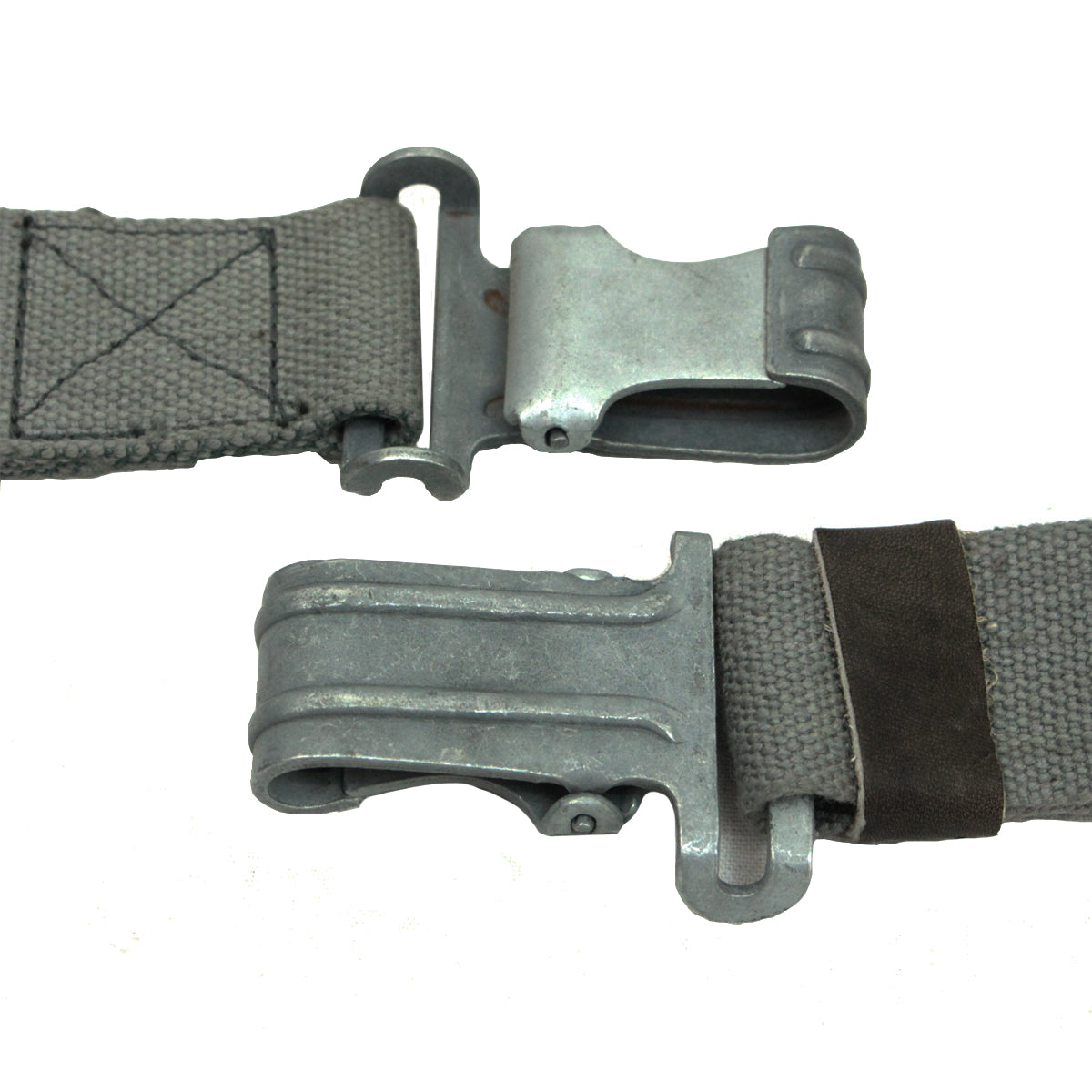 Close-up detail of two metallic spring-loaded clips on an authentic East German RPG7 surplus sling showing the grey steel finish.