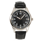 Close-up front view of Eaglemoss British 1950s Army Watch with black face, white indices, and adjustable black leatherette strap.