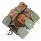 Multiple vintage Hungarian army compasses and leather pouches showing natural surplus variation