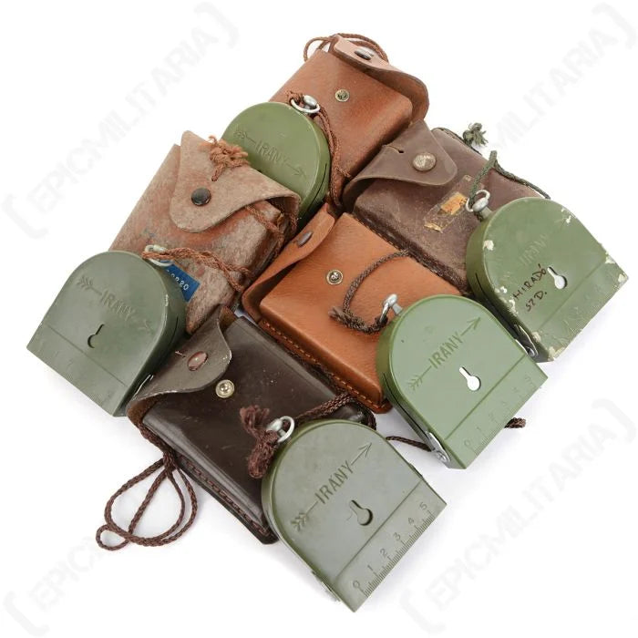 Multiple vintage Hungarian army compasses and leather pouches showing natural surplus variation