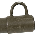 Close-up of the steel collar and guy line ring on a vintage Bundeswehr wooden tent stake showing weathered olive paint.