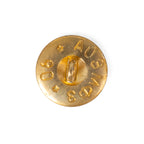 Reverse side of a 1990 Soviet military brass button, showing the wire loop shank, Cyrillic factory markings, and stamped production year.