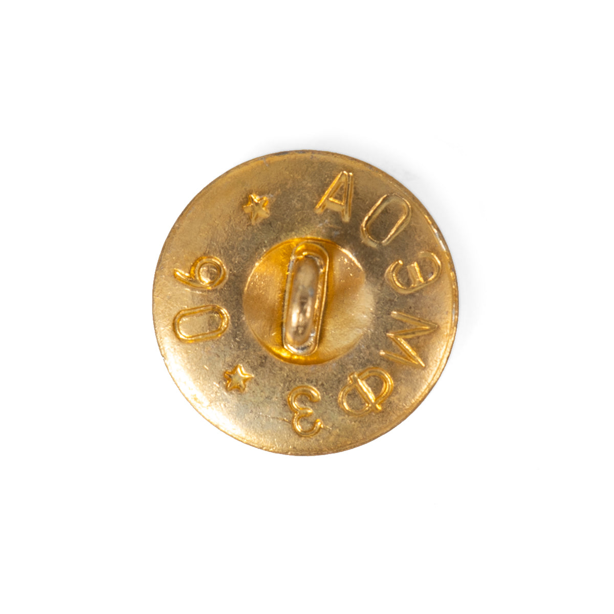 Reverse side of a 1990 Soviet military brass button, showing the wire loop shank, Cyrillic factory markings, and stamped production year.