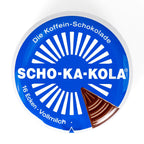Top-down view of the blue and white Scho-Ka-Kola caffeine chocolate tin lid with 16-wedge design.