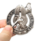 Close-up of US Army Recruiter Badge held in hand showing scale and silver finish