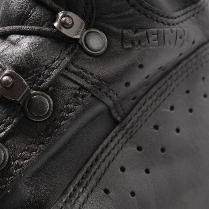 Detail of speed lacing eyelets and embossed Meindl brand logo on the waterproof leather upper