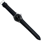 Full length front view of the German Army service watch laid flat with black textured PU strap