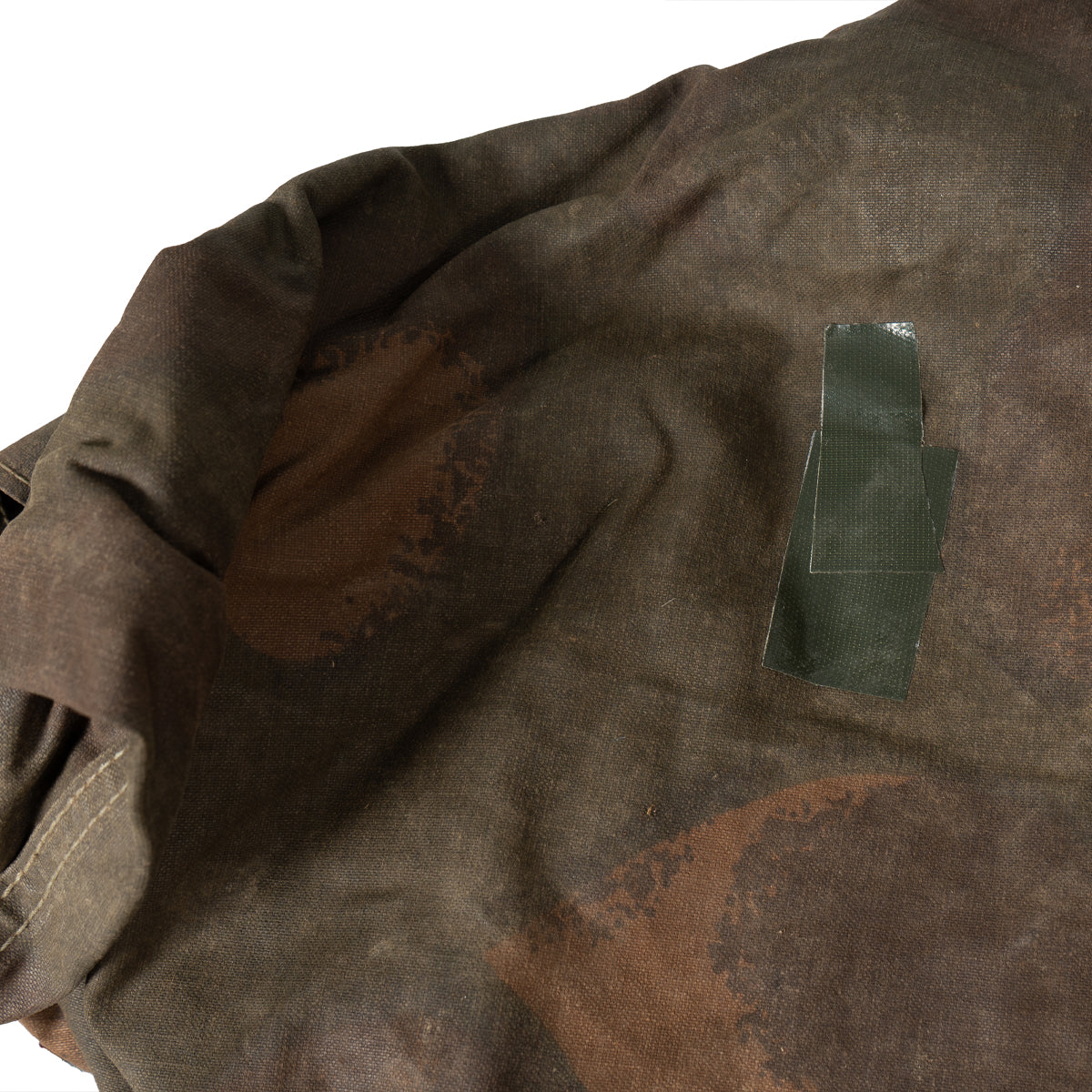 Detail of a small repair patch on the Hungarian army canvas fabric for maintenance and durability.