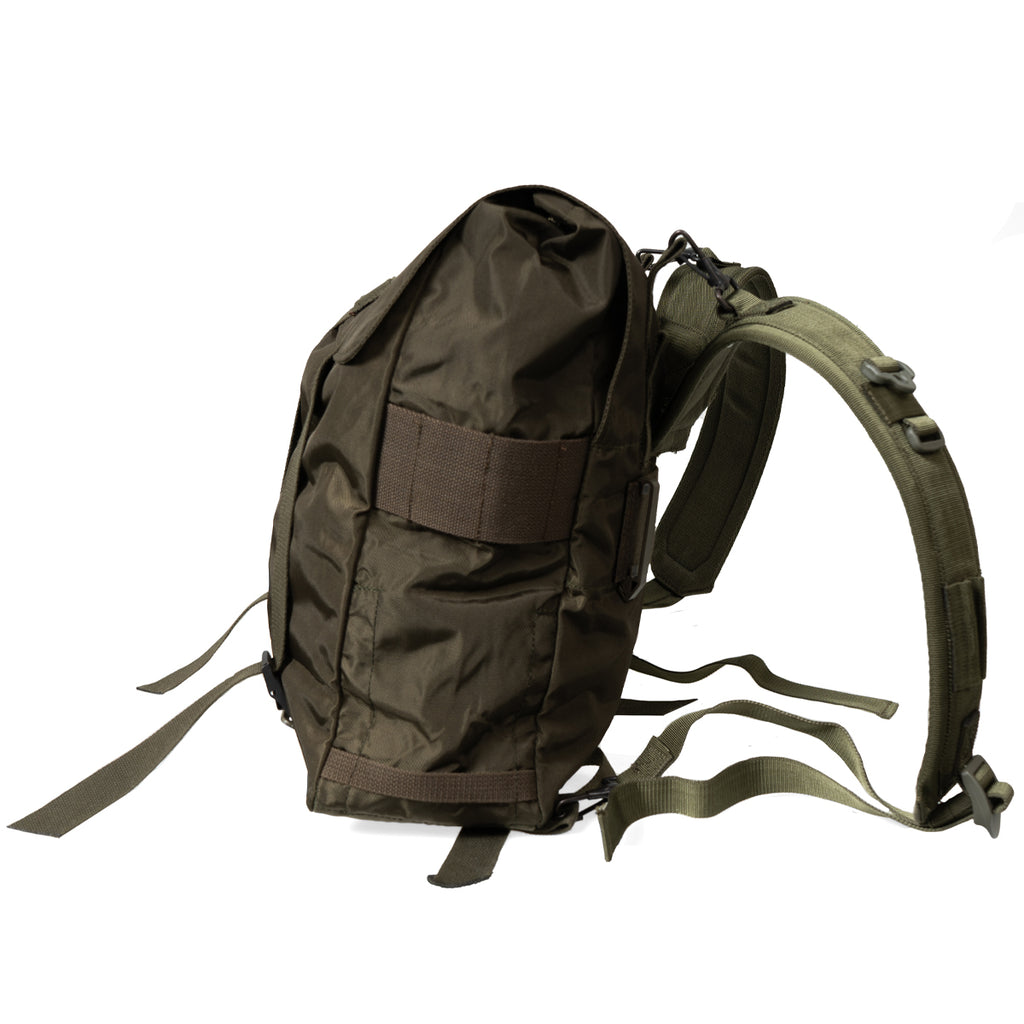 Green backpack with multiple straps on a white background