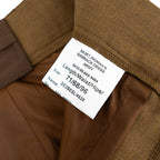 Internal product label on a British Army Barrack Dress Skirt detailing size, material, and NSN military markings.