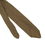 Reverse side of a WW2 British Army officer's tie showing the unlined construction and simple pointed tip of the khaki rayon fabric.