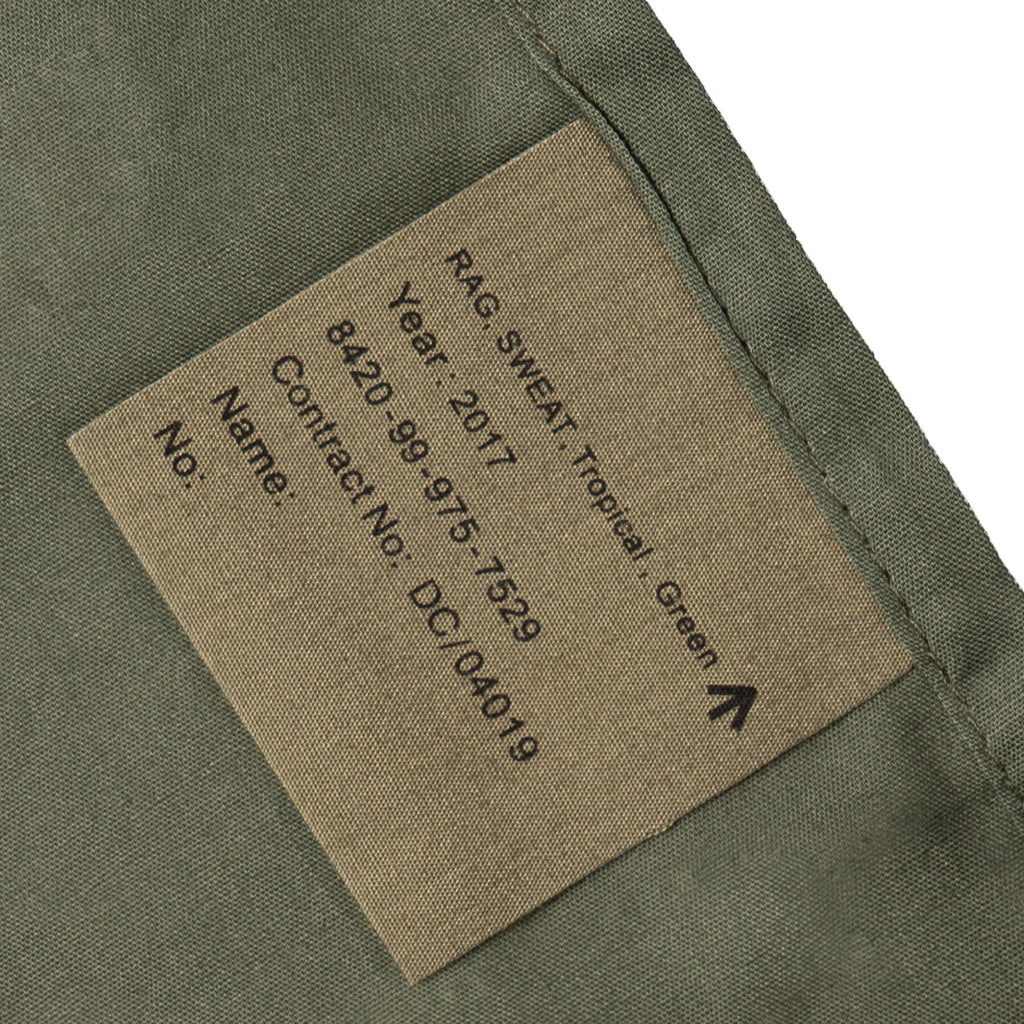Close-up of military issue tag on 2017 British Army sweat rag showing NSN 8420-99-975-7529 and tropical green fabric.