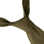 Close-up of the durable khaki cotton-blend fabric and knot construction on an authentic British Army service dress tie.
