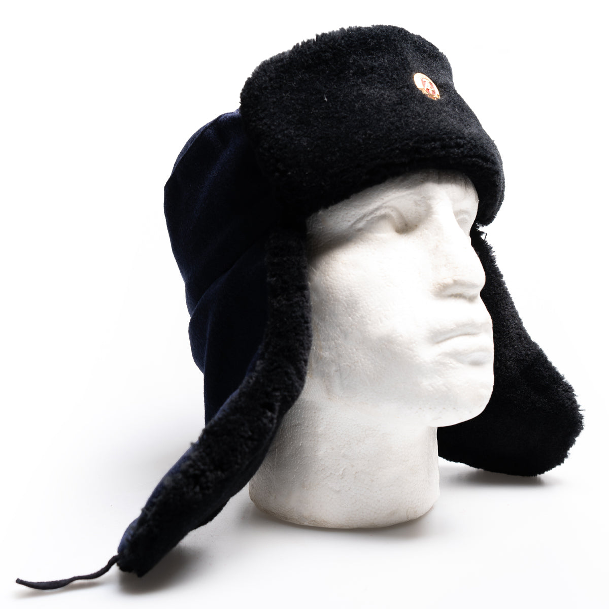 Genuine East German NVA Ushanka hat worn on a mannequin with ear flaps hanging down for winter protection.