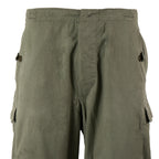 Close-up of the front waist and hip area of original NVA combat trousers, highlighting the durable fabric and pocket placement.