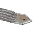 Detail of the pointed metal end tip on an original NVA Rödelriemen strap, showing authentic cold war field-used condition.