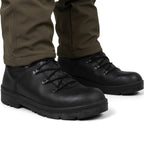 Angle view of black combat boots worn on feet, demonstrating the fit and the mid-foot locking clamp lacing.