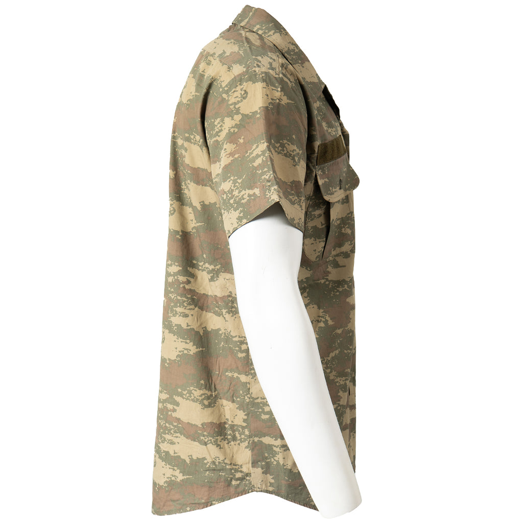 Side profile of a Turkish Army field shirt on a mannequin, highlighting the lightweight cotton-blend fabric, short sleeves, and distinct military camo pattern.