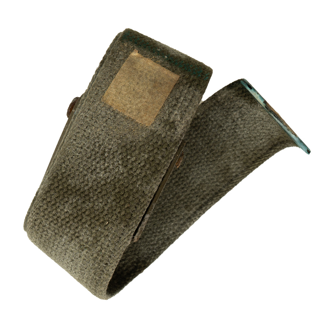 Green fabric belt with a patch on a white background