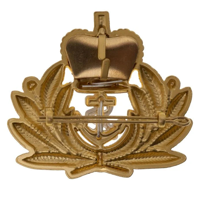 Rear view of Royal Navy Officer cap badge showing gold staybrite finish, mounting lugs, and split pin