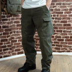 Austrian Army Anzug 03 olive cargo trousers being worn with leather military combat boots.