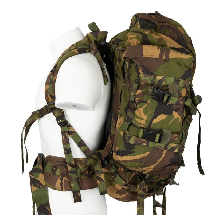 Side profile view of the rucksack on a mannequin, illustrating the load-bearing suspension system and padded hip belt.