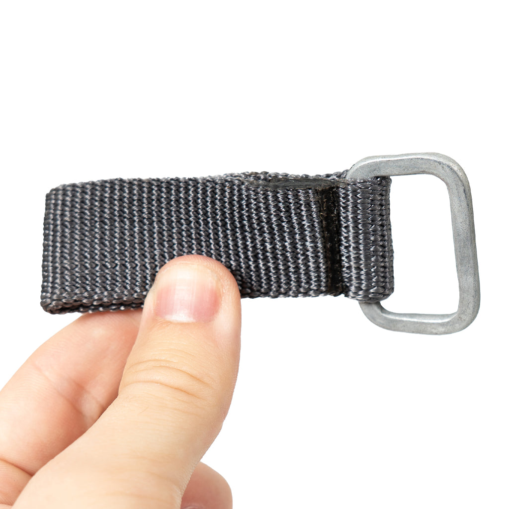 Handheld close-up of a rugged NVA nylon belt loop, demonstrating the compact size and tight construction for military gear.