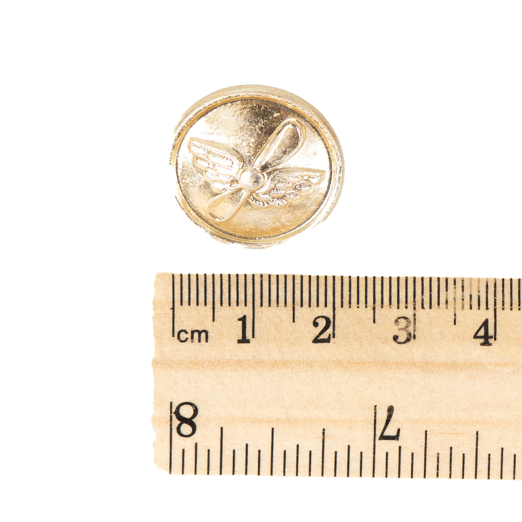 Top-down view of a 22mm Aeroflot gold button next to a ruler for scale, illustrating its size and classic Soviet civil aviation design.