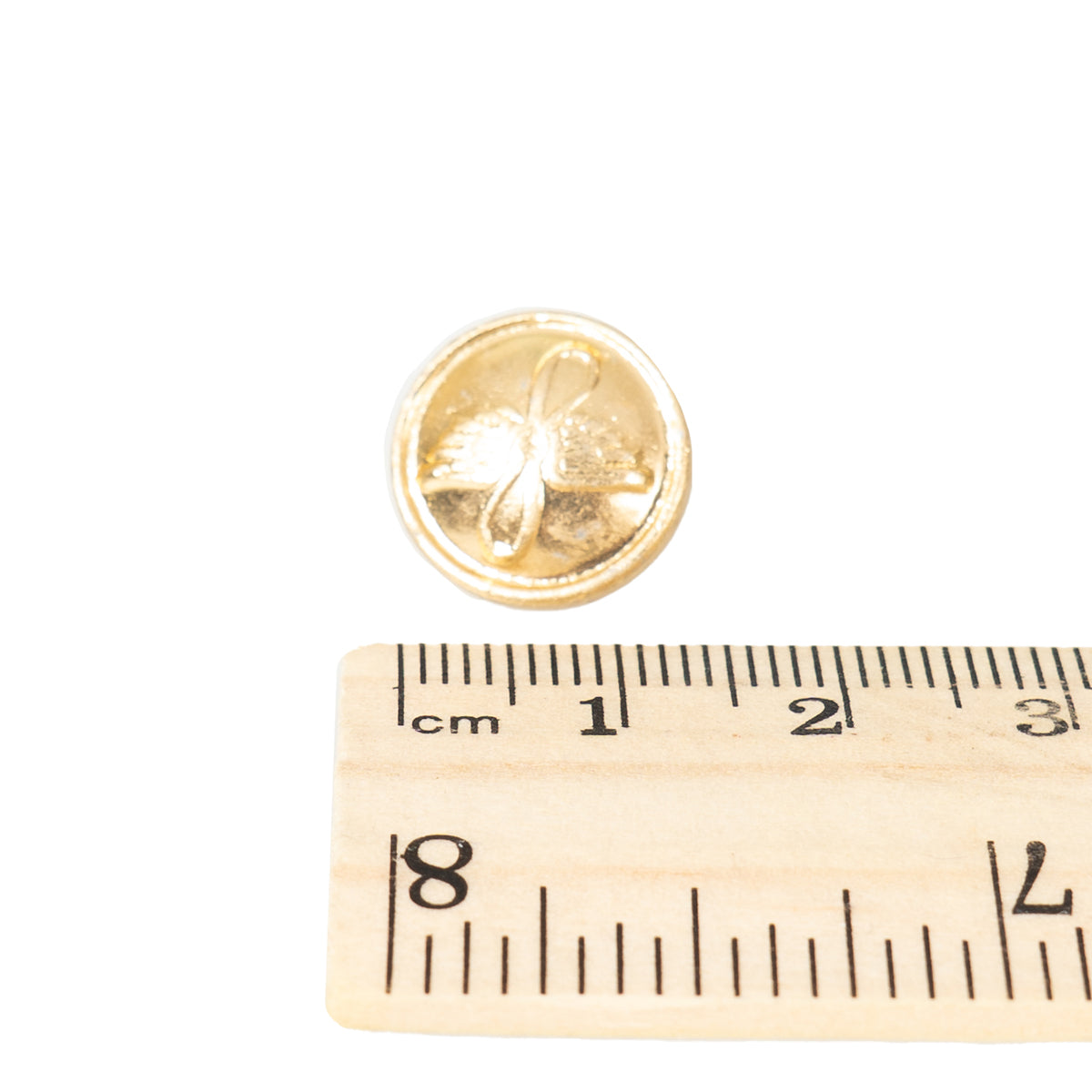 Aeroflot gold pilot uniform button measured against a ruler, demonstrating the standard 22mm diameter for restoration projects.