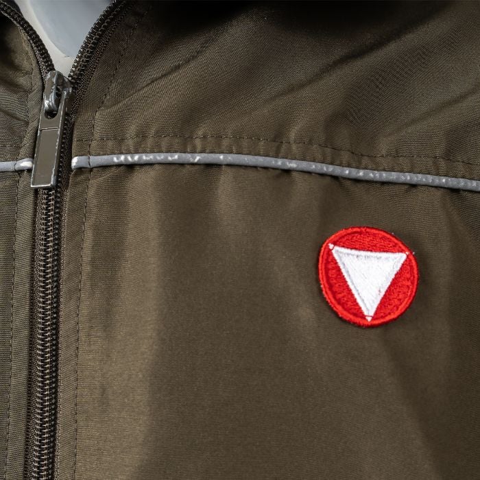 Detail shot of the embroidered circular red and white Austrian Bundesheer national insignia on the left chest.