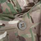 Detailed view of lower bellows pocket flap, slotted button on webbing tape, and MTP camouflage weave